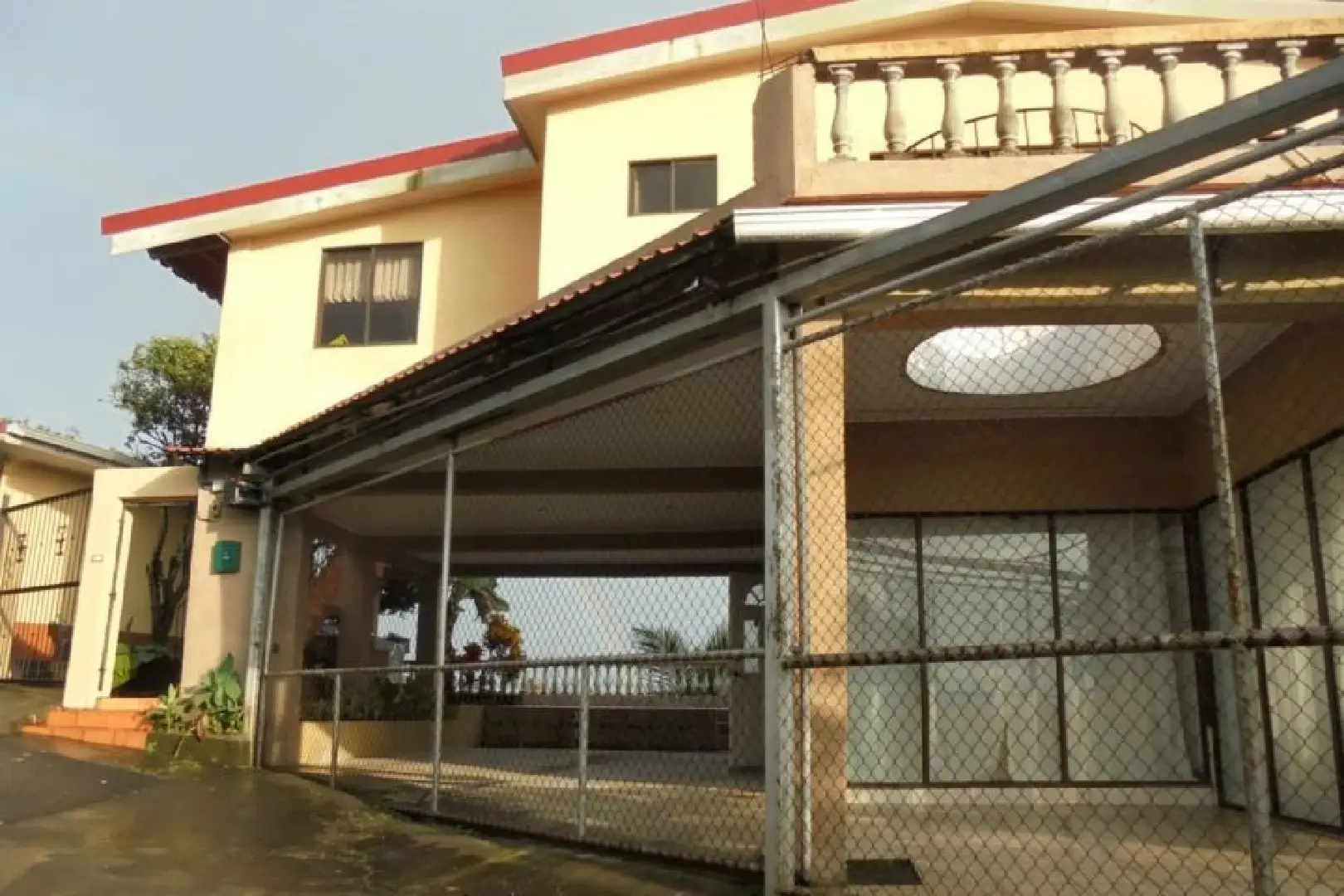 A building with a metal fence and a large open area.