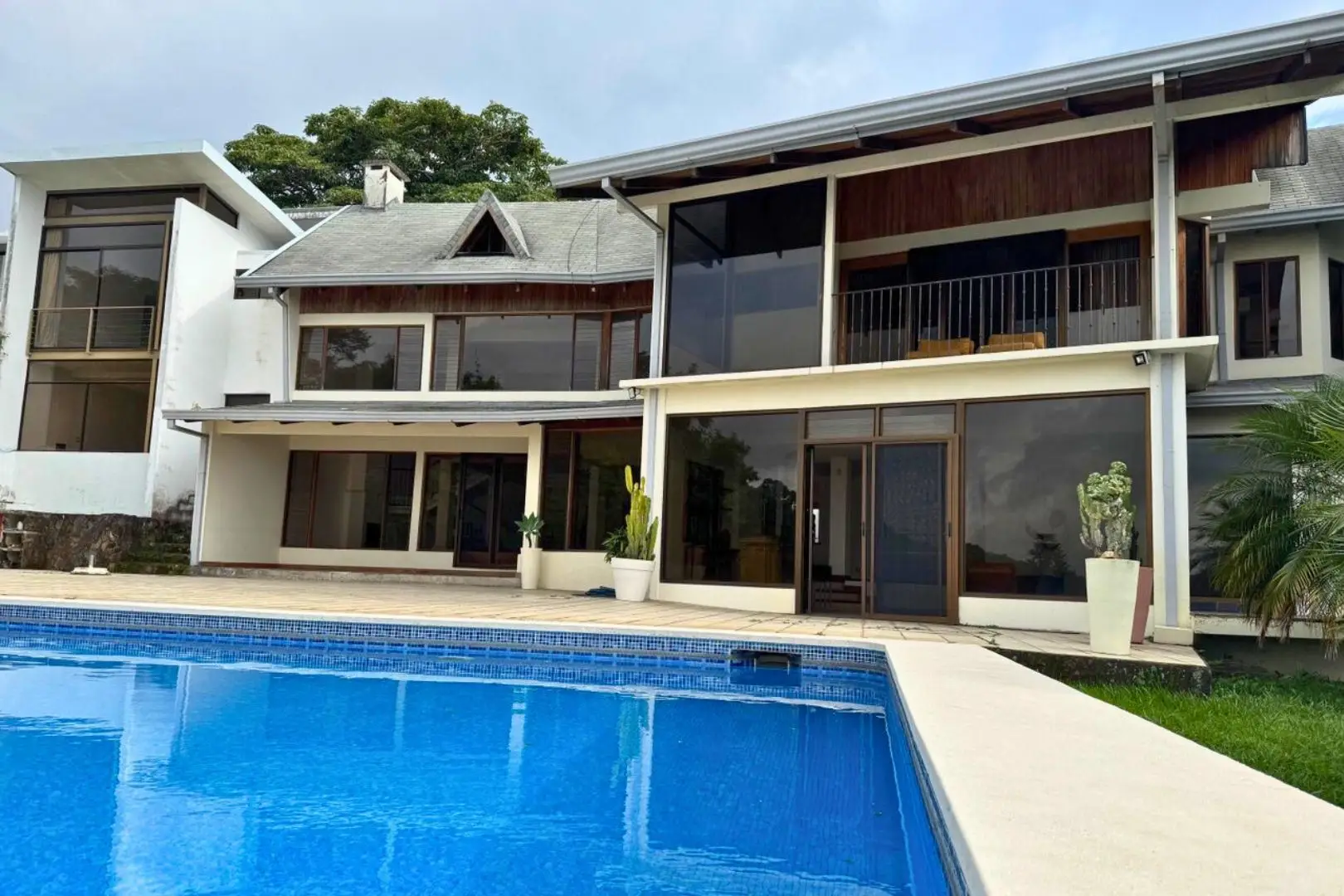 A large pool in front of a house.