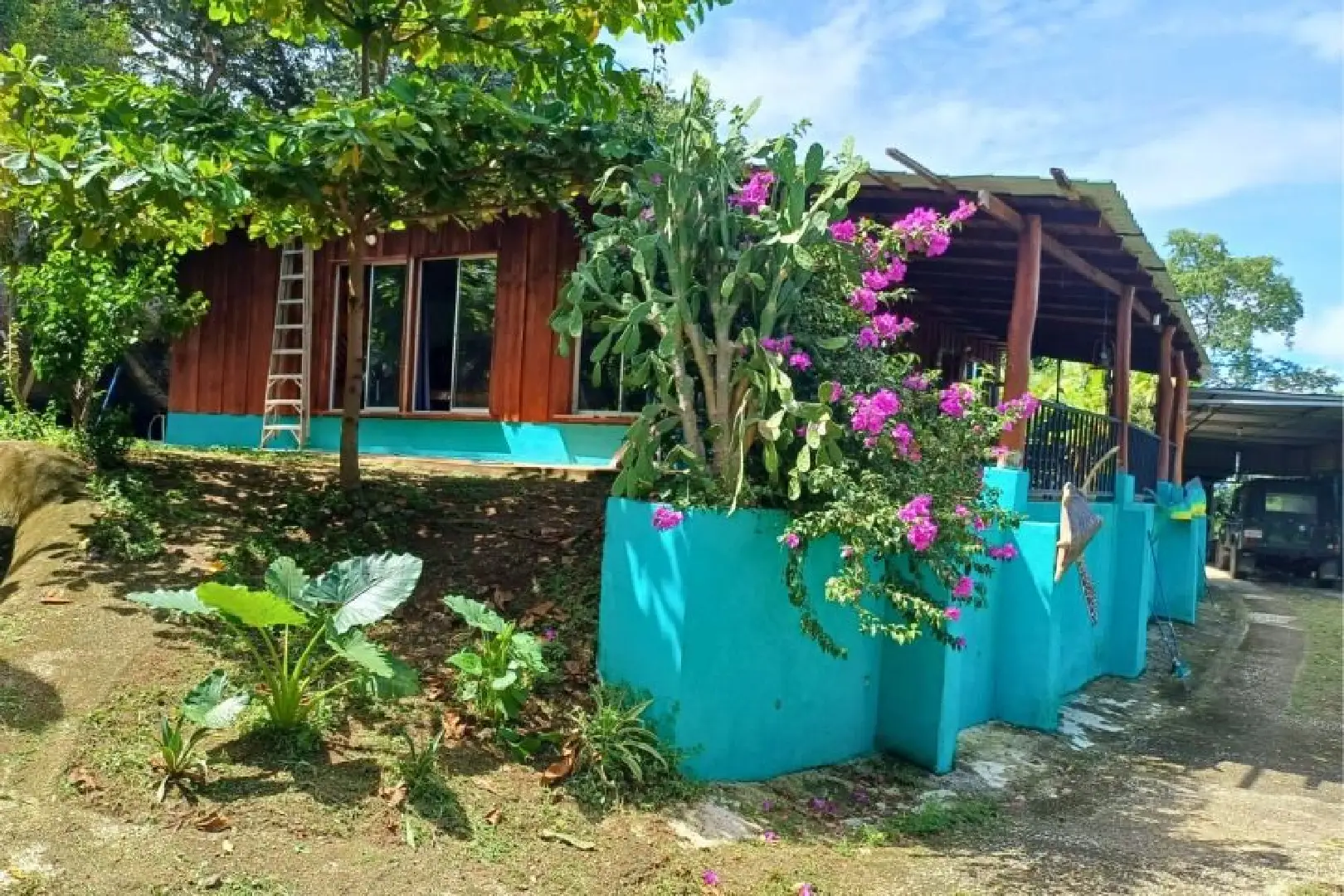 A blue planter with flowers in it