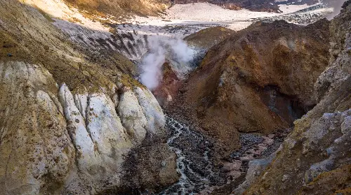 A picture of the side of a mountain with steam coming out.